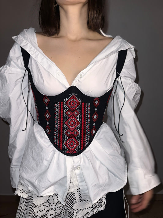 Folk corset with red geometric motifs